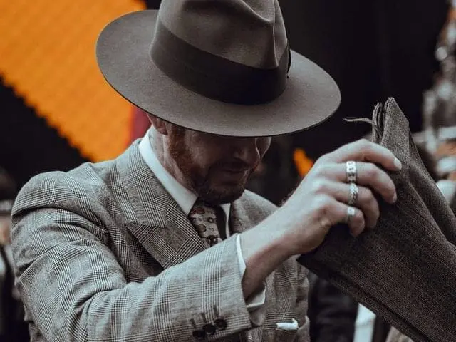 Elegancko ubrany mężczyzna z kapeluszem na głowie. 