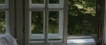 Przytulna sypialnia wieczorem z otwartym oknem i książką — rutyna przed snem