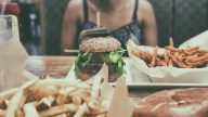 Burger i frytki na stole.