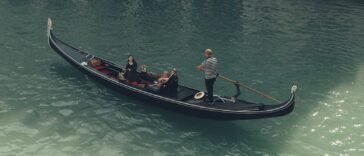 Turyści płynący gondolą po Canal Grande w Wenecji