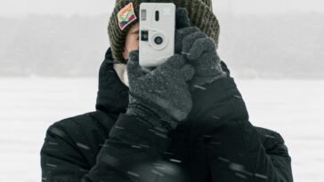 Osoba robi zdjęcie telefonem na śniegu, bateria telefonu na mrozie